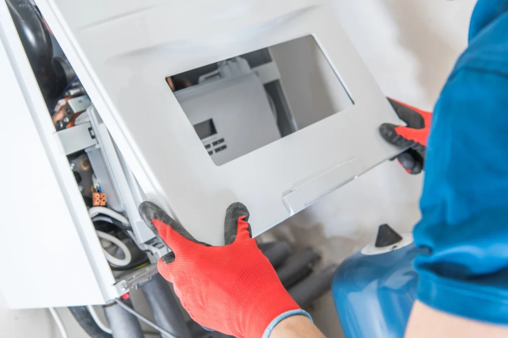 man closing lid during furnace tune up in Spokane